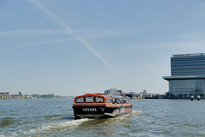 Amsterdam 1h Canal Cruise by Semi-Open Boat with Audio Guide - Houseboats, leafy banks, and the Heineken brewery