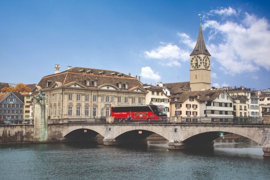 Zurich: City Top Attractions Tour by Bus with Audio Guide - The lake view and distant snow-capped mountains